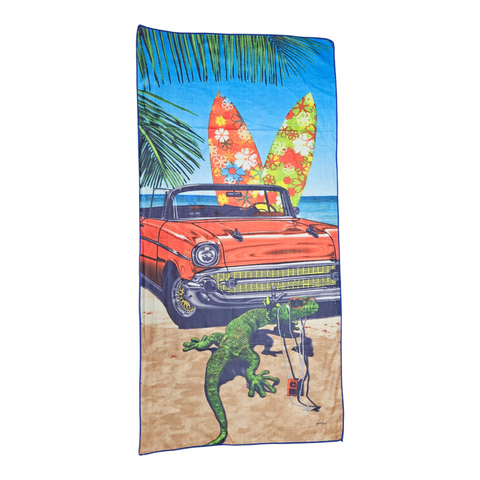 Beach towel with a vintage car, surfboards, and lizard design on a palm tree and blue sky background.