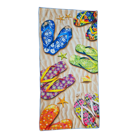 Beach towel with colorful flip-flop design on a sandy background