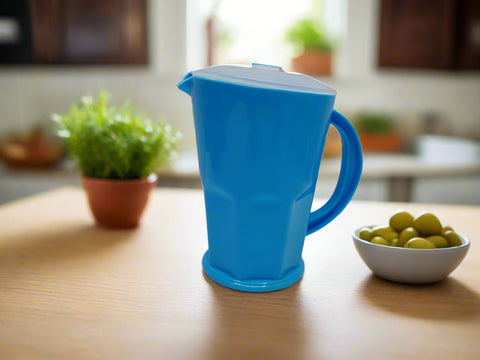 Blue pitcher with a white lid on a white background
