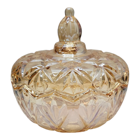 Decorative glass container with a lid on a white background