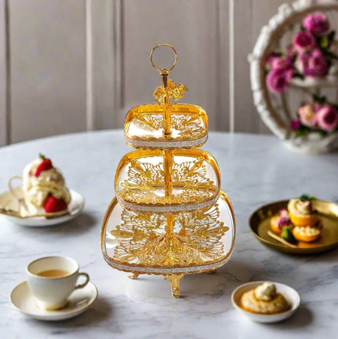 Gold three-tiered decorative stand on a white background