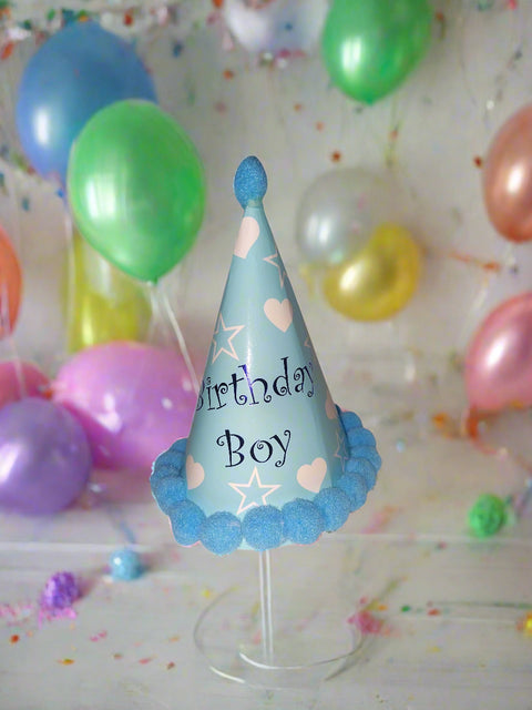 Blue birthday hat with 'Birthday Boy' text on a white background