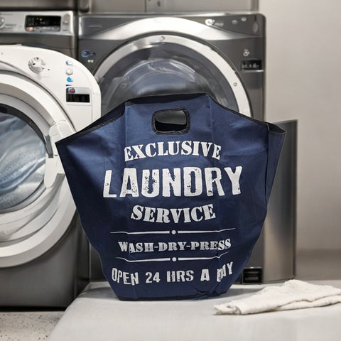 Navy blue laundry bag with text in front of a washing machine and dryer