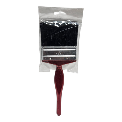 Red paint brush with black bristles in a clear plastic bag on a white background