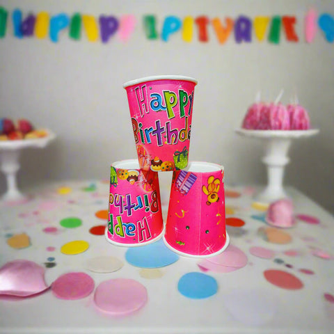 Three colorful birthday-themed cups on a white background