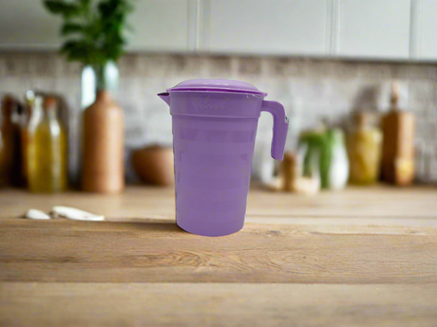 Purple pitcher with a lid on a white background
