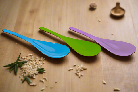 Three colorful spoons (blue, green, purple) on a white background