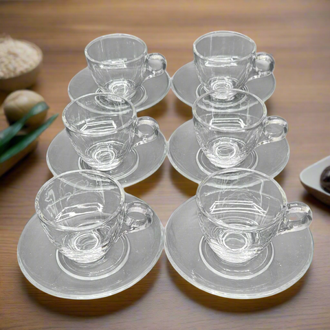 Set of clear glass coffee cups and saucers on a white background