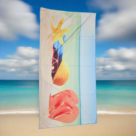 Towel with beach-themed design featuring a starfish, shell, and coral on a white background