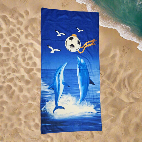Towel with dolphins and a soccer ball design on a blue background