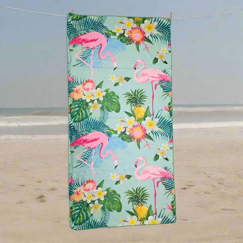 Towel with flamingo and floral design on a light blue background