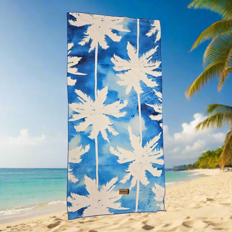 Towel with white palm tree design on a blue background