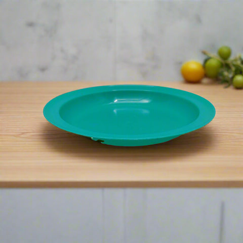 Turquoise plastic bowl on a white background