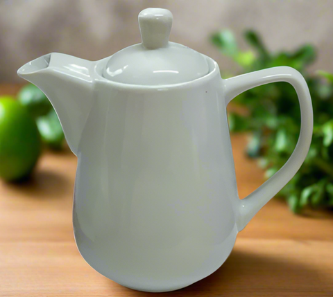 White ceramic teapot on a white background