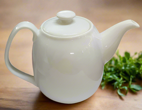 White ceramic teapot on a white background