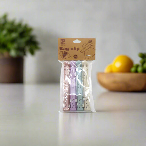 Packaged bag clips with a decorative label on a neutral background