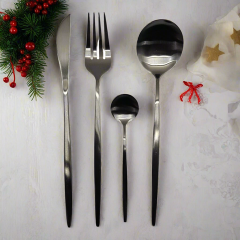 Set of silver cutlery with black accents on a white background