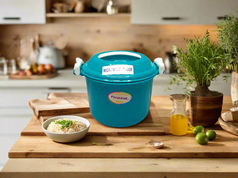 A blue microwave rice cooker on a wooden kitchen countertop, surrounded by various kitchen items and a bowl of rice in the foreground.