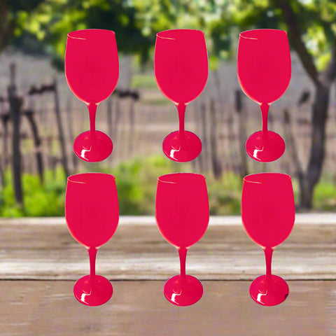 Six bright pink wine glasses on a white background