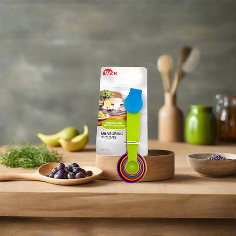 Set of colorful measuring spoons with packaging on a kitchen counter