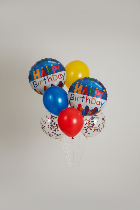 Bouquet of colorful birthday balloons on a white background