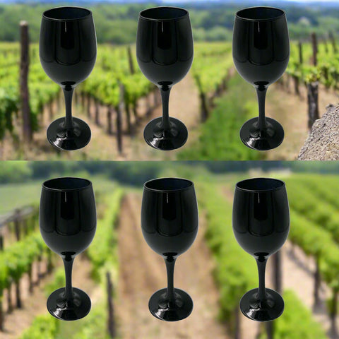Set of six black wine glasses on a white background