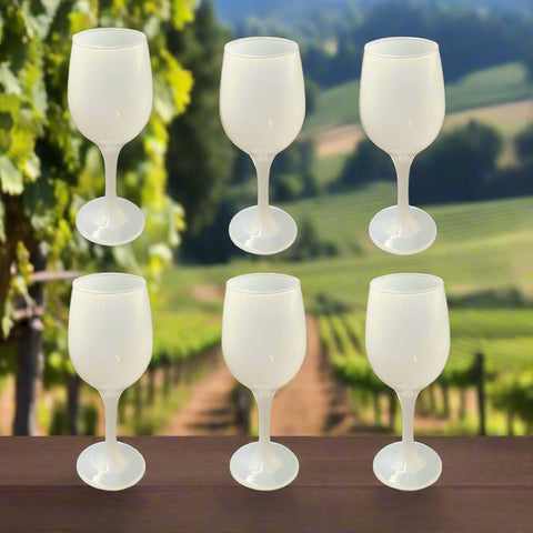 Set of six white wine glasses on a white background