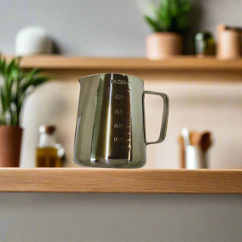 Stainless steel pitcher with measurement markings on a white background