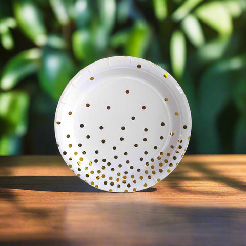 White plate with gold polka dots on a white background